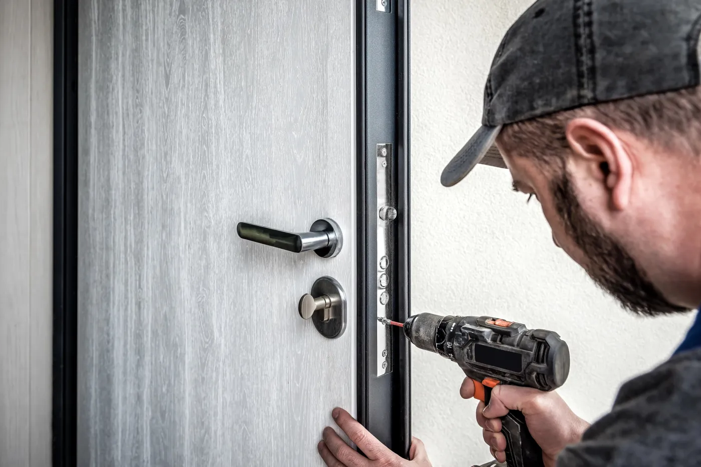 Serrurier posant une serrure multipoints sur une porte blindée à Paris